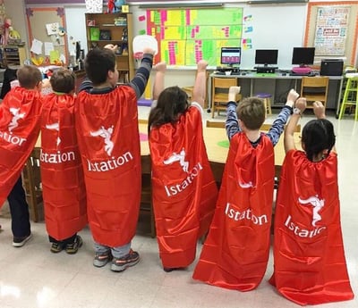 Istation students in red capes being superheros