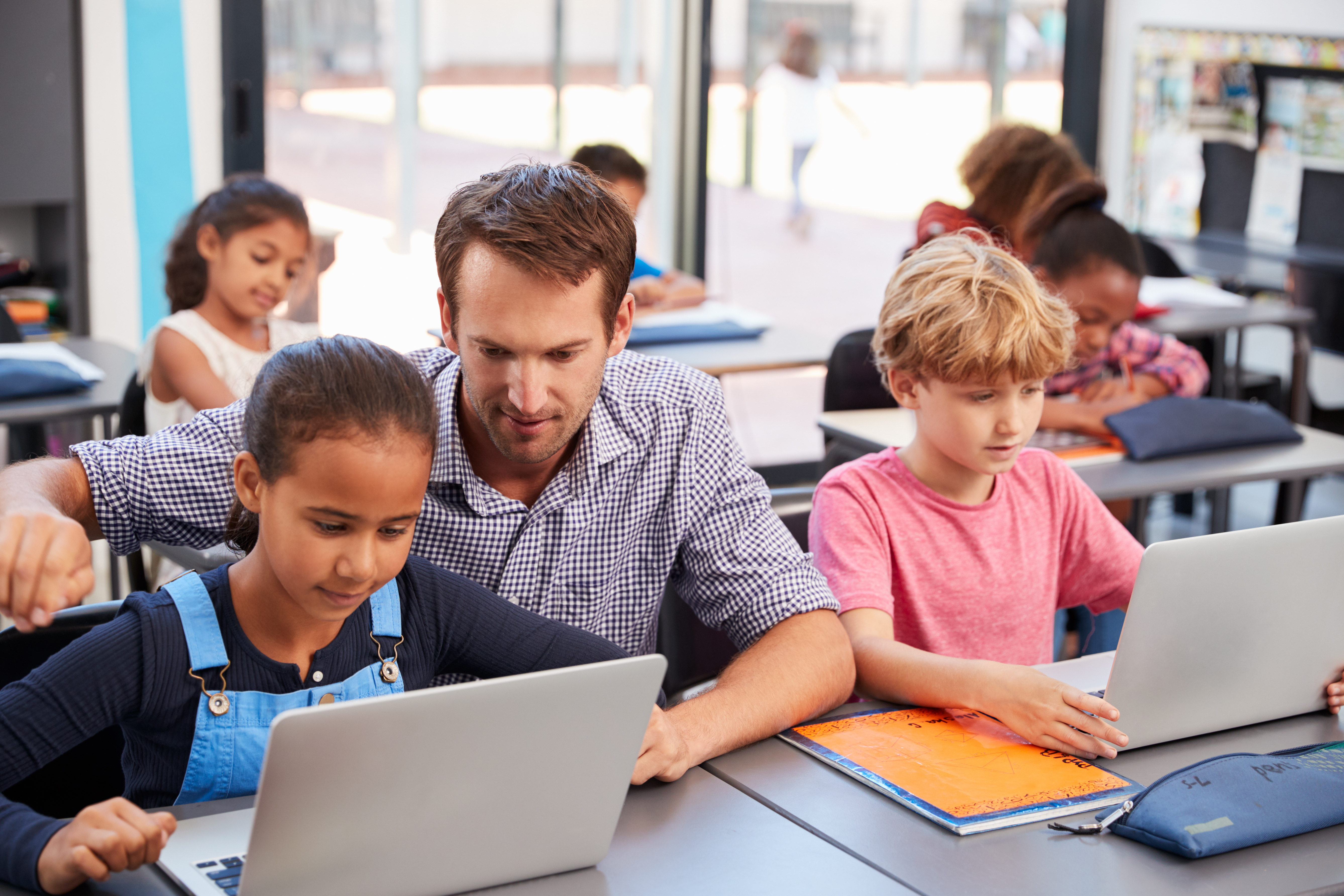 Teacher working with student on computer