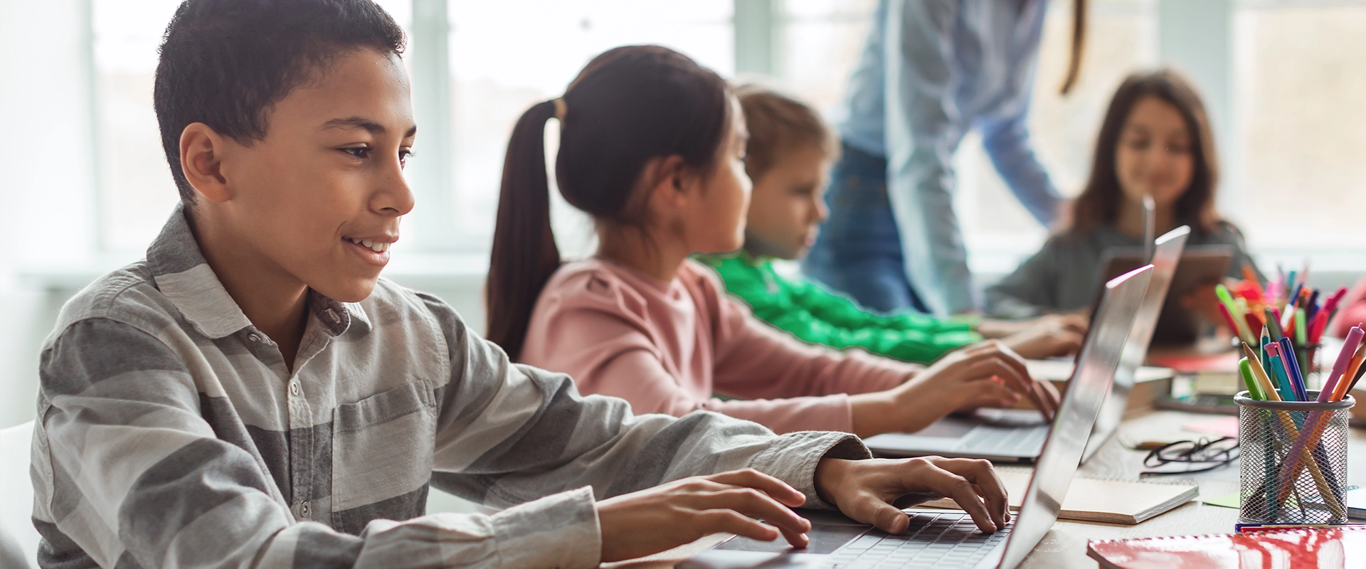 cheerful-schoolboy-using-laptop-1920x800