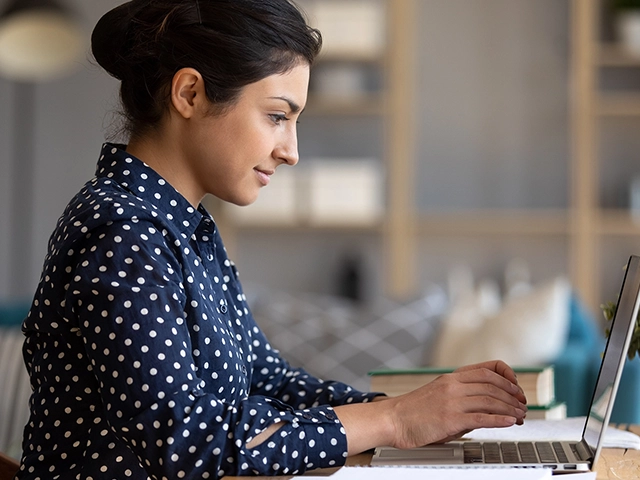 Female-Educator-Sitting-Laptop-640x480