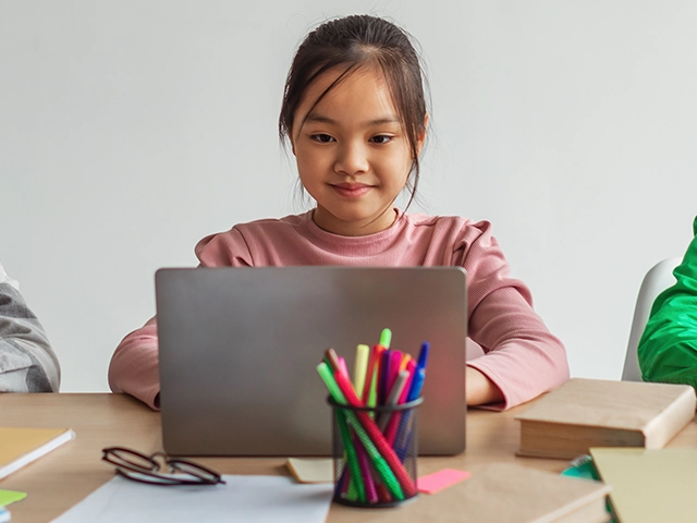 Students-Using-Laptops-At-Desk-640x480