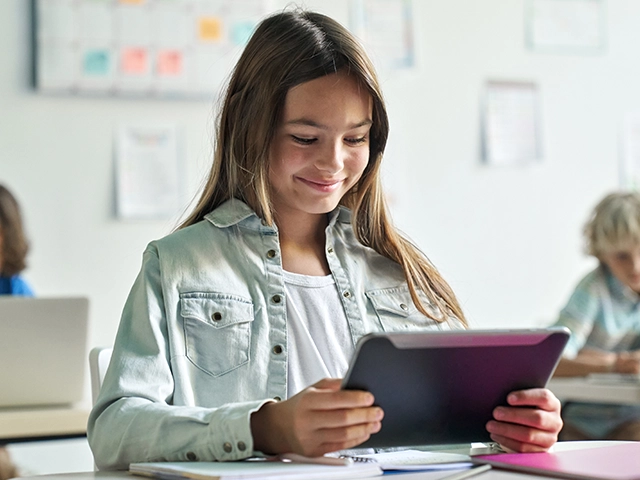 smiling-elementary-girl-studying-640x480